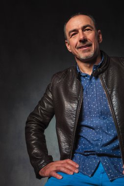 man in leather jacket resting hands