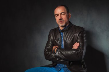 man in leather jacket posing looking at the camera