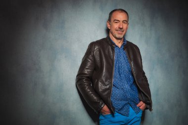 Olgun erkek deri ceket ayakta gri Studio