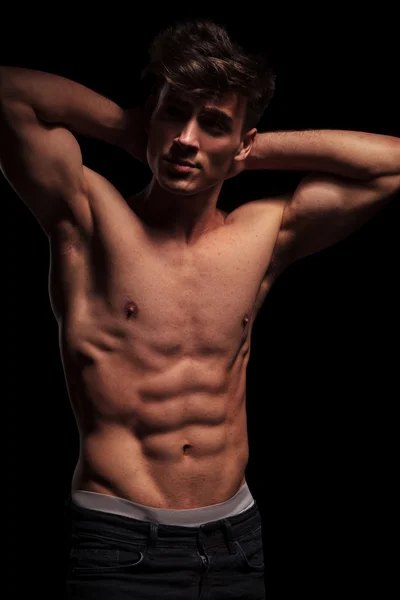 Muscular topless man flexing his arms — Stock fotografie