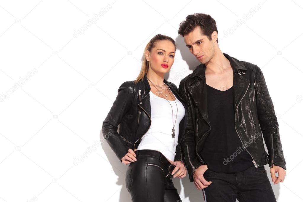 young fashion couple in leather clothes posing in studio