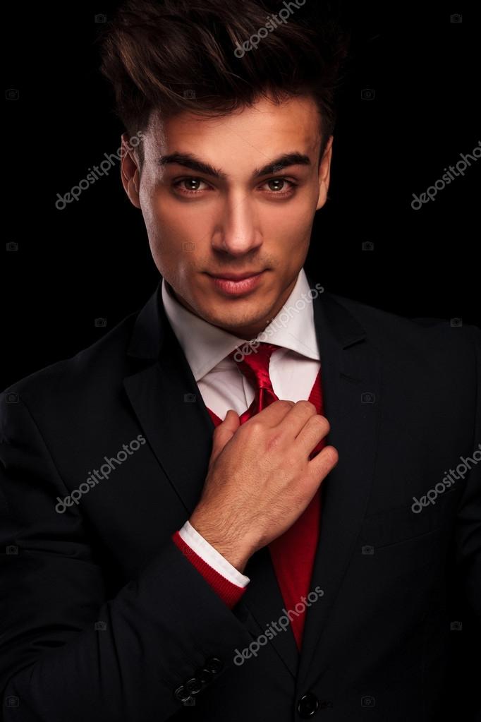 Male Model In Black Suit Fixing His Red Tie Stock Photo By ©feedough ...