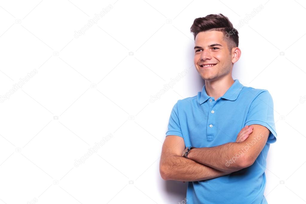 young man in blue polo shirt posing hands crossed