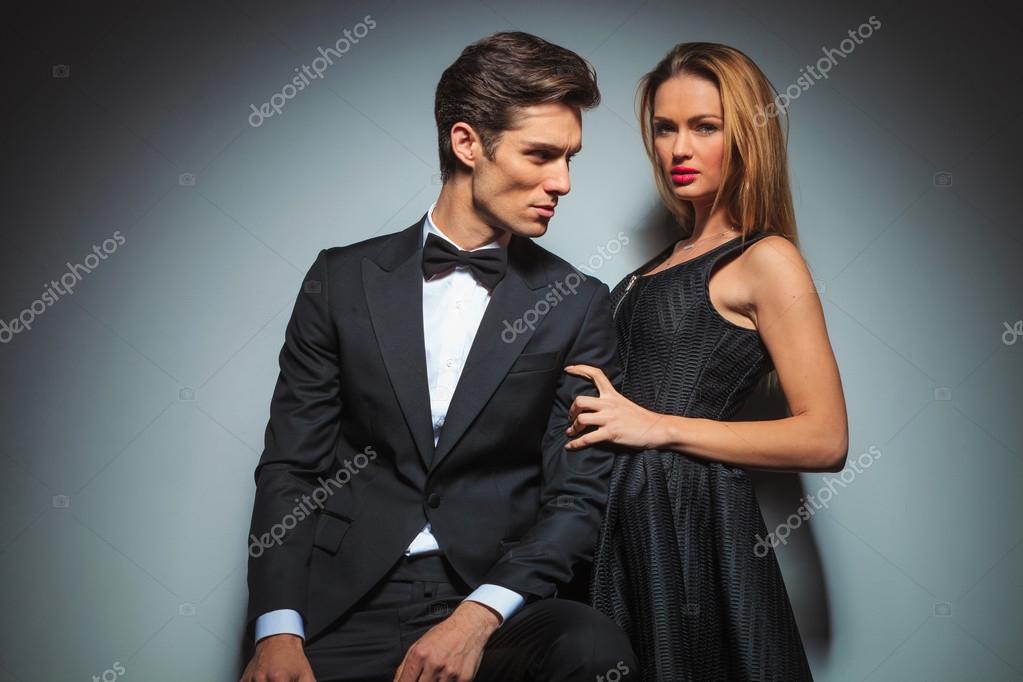 Fashion couple posing on grey studio background Stock Photo by ©feedough  64958773