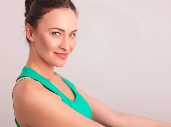 Side view of a happy woman in green undershirt — Stock Photo, Image