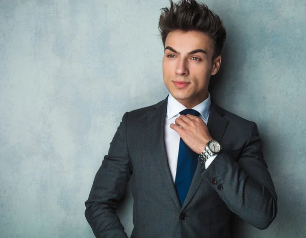 Jovem empresário fixando sua gravata azul — Fotografia de Stock