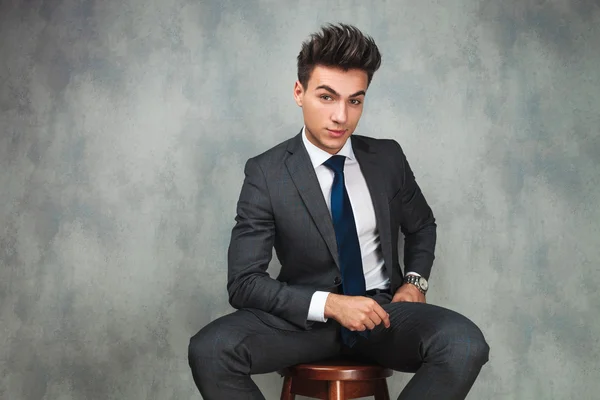 Attractive seated young business man — Stock Photo, Image