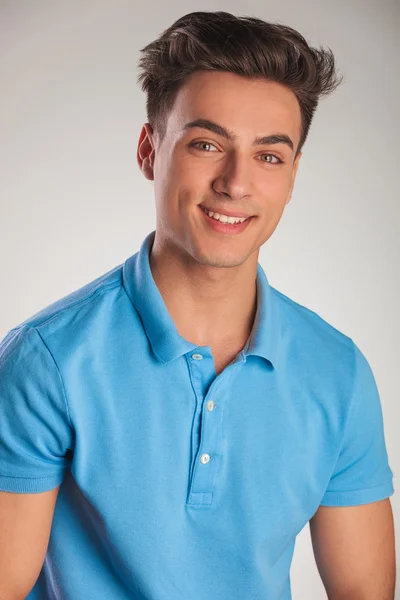 Positive young casual man in polo shirt laughing — Stock Photo, Image