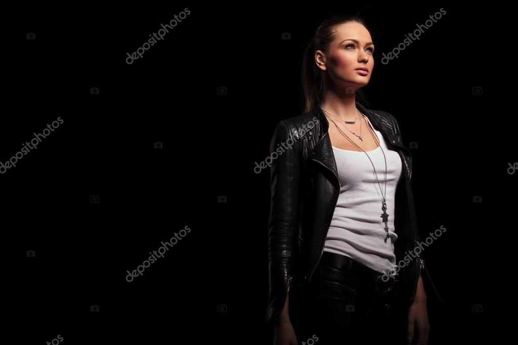 Side view of a woman in leather clothes looking up Stock Photo by ...
