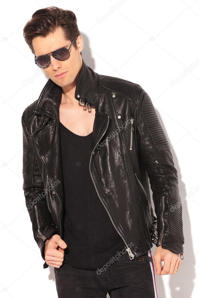 serious fashion model in leather jacket and sunglasses