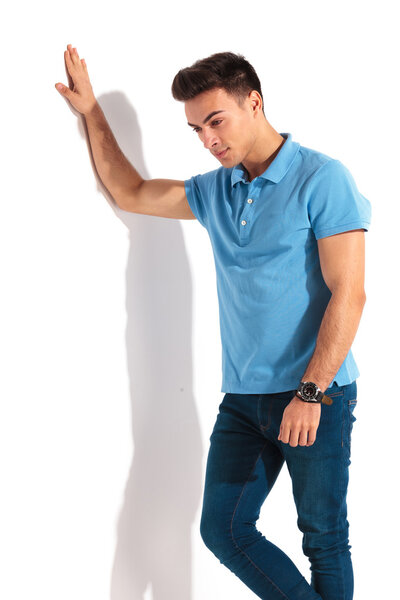 sad casual man in polo shirt is looking down