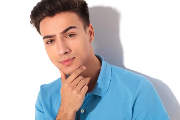 Thoughtful young casual man in polo shirt — Stock Photo, Image