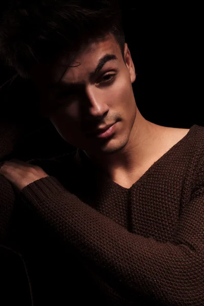 Young man posing on black studio backround — Stock Photo, Image