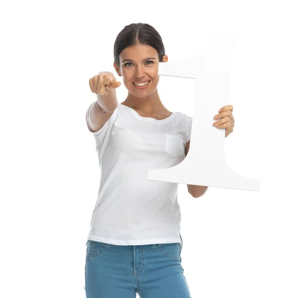 Positive Casual Woman Holding Number One Pointing While Standing White — Stock Photo, Image