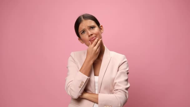 Confused Young Businesswoman Pink Suit Crossing Arms Touching Chin Thinking — Stock Video