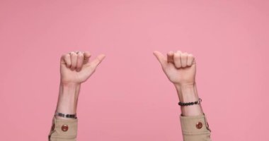 two arms showing palms, pointing at the camera, making an ok sign and celebrating succes against pink background