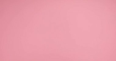 two hands entering, gesturing an I love you sign on pink background