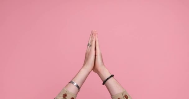 Two Hands Holding Together Gesturing Praying Sign Pink Background — Stock Video