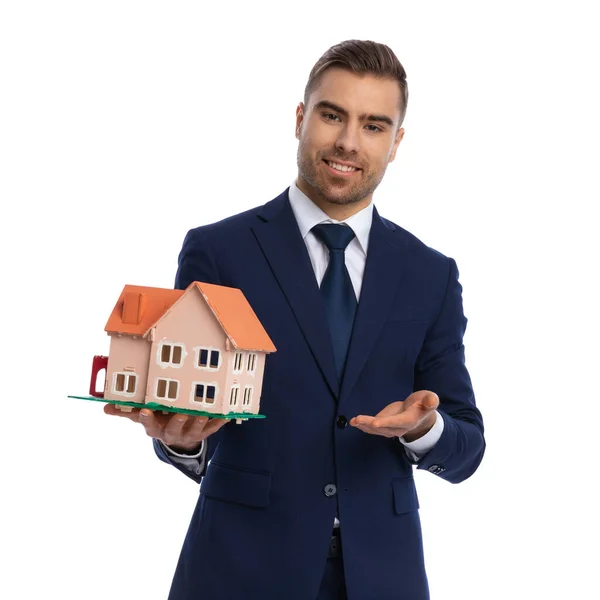Elegant Young Businessman Navy Blue Suit Smiling Recommending House Model — Stock Photo, Image