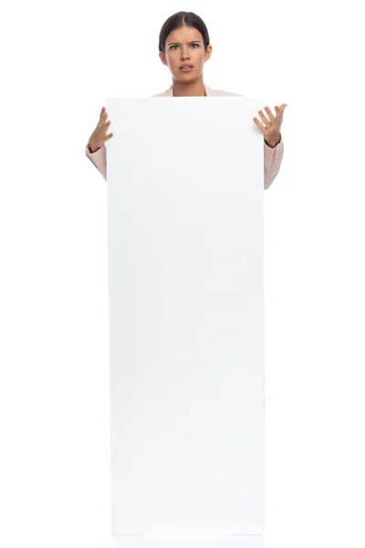 Confused Businesswoman Pink Jacket Covering Body Empty Board Standing White — Stock Photo, Image