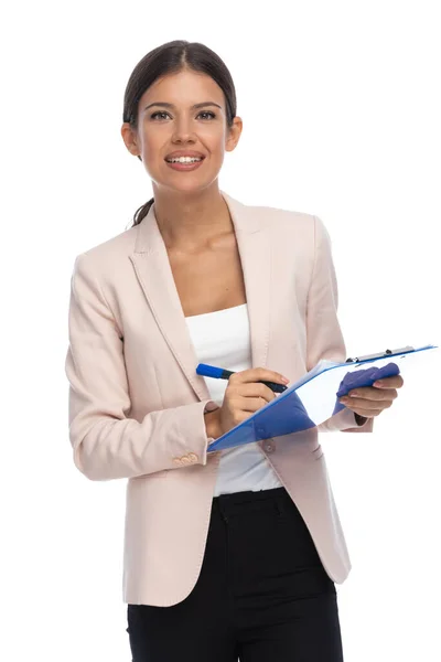 Attractive Brunette Businesswoman Pink Jacket Holding Clipboard Taking Notes Smiling — Stock Photo, Image