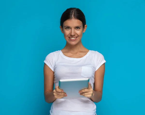 Young Casual Woman Holding Tablet Her Hands Smiling Camera Blue — Stock Photo, Image