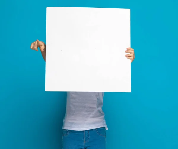 Casual Woman Hiding Blank Billboard Pointing Camera Blue Background — Stock Photo, Image