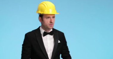 Yakışıklı işadamı işaret ediyor, çerçeveliyor ve başparmak işareti yapıyor.