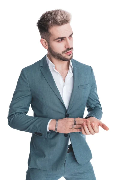 Portrait Young Businessman Suit Looking Side Rubbing Palms White Background — Stock Photo, Image