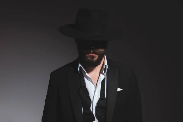 Portrait Mysterious Businessman Wearing Black Hat Tuxedo Undone Bowtie Gray — Stock Photo, Image