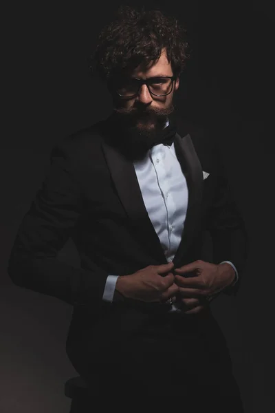 Cool Businessman Looking Camera Attitude Fixing His Tuxedo Sitting Gray — Stock Photo, Image