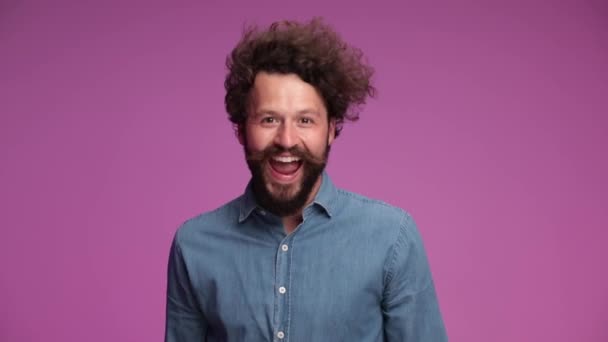 Young Casual Man Jumping Waving Smiling Wide Getting Very Excited — Stock Video