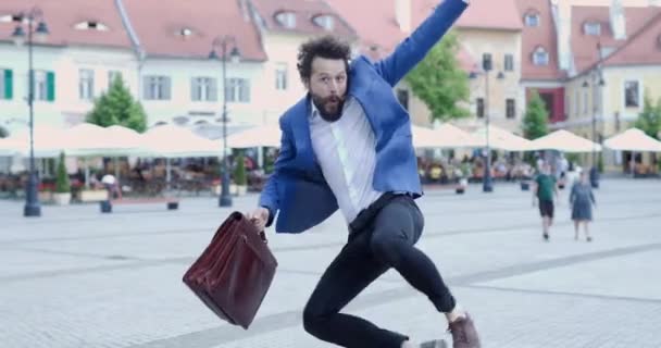 Joven Barbudo Feliz Sosteniendo Maletín Café Saltando Aire Divirtiéndose Frente — Vídeos de Stock