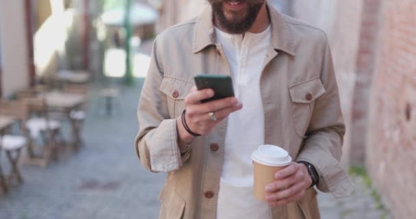 Young Casual Guy Holding Phone Cup Coffee Wearing Eyeglasses Smiling — Stock Video