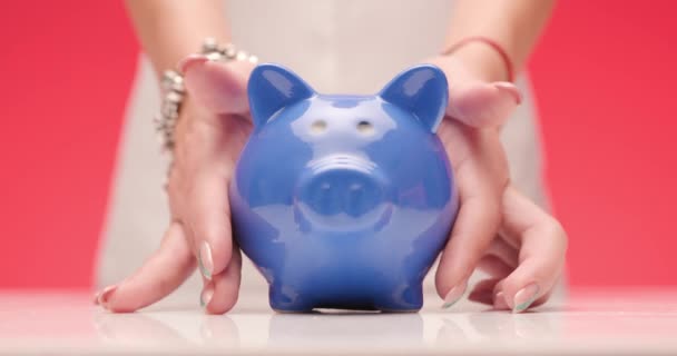 Mãos Femininas Segurando Sacudindo Banco Porquinho Azul Colocando Mesa Recomendando — Vídeo de Stock