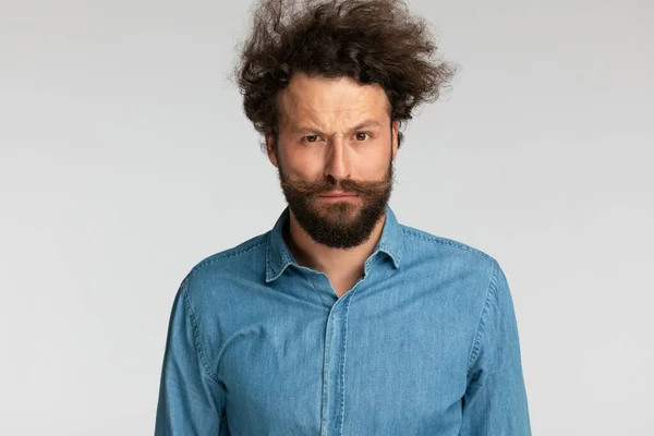 Serious Bearded Fashion Model Denim Shirt Frowning Posing Grey Background — Stock Photo, Image