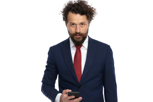 Przystojny Biznesmen Smsy Jego Telefon Podczas Patrząc Aparat Białym Tle — Zdjęcie stockowe