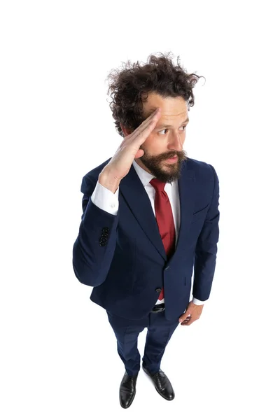 Young Businessman Saluting Looking Side White Background — Stock Photo, Image