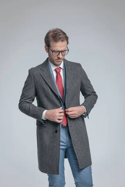 Dramatic Businessman Closing His Coat Looking Wearing Eyeglasses Gray Background — Stock Photo, Image