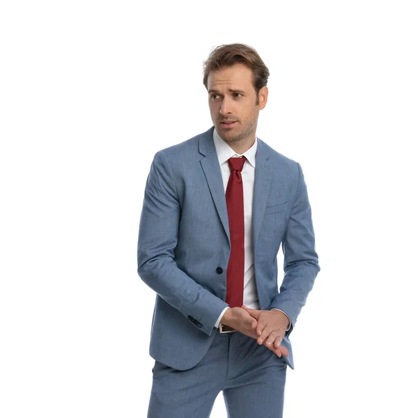 Attractive Businessman Blue Suit Looking Side Rubbing Palms Standing Posing — Stock Photo, Image