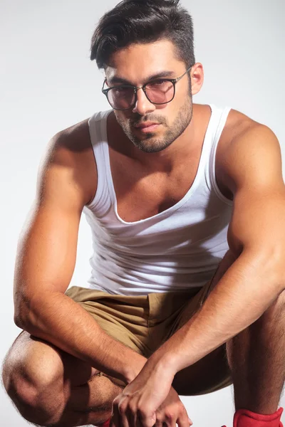 Serious casual man in undershirt standing crouched — Stock Photo, Image