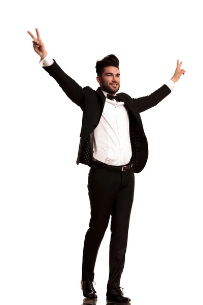 Side view of a man in tuxedo with hands up — Stock Photo, Image