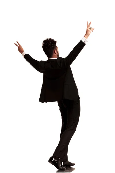 Back view of a fashion man in tuxedo winning — Stock Photo, Image