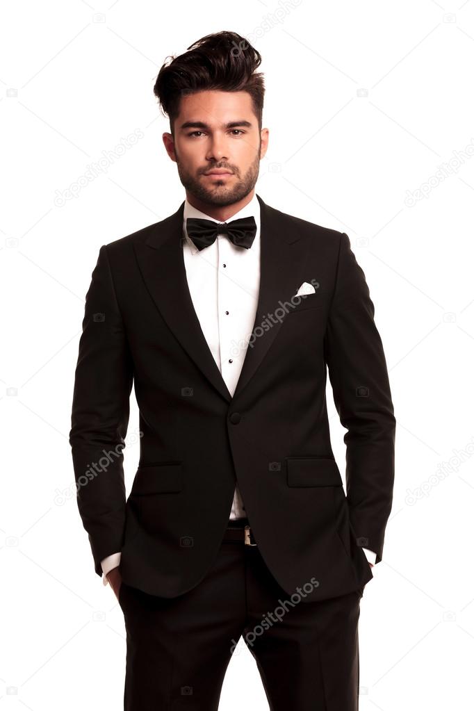 Stylish man standing with hands in pockets