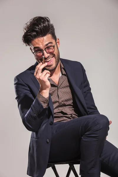 Happy young elegant man laughing hard while smoking — Stock Photo, Image