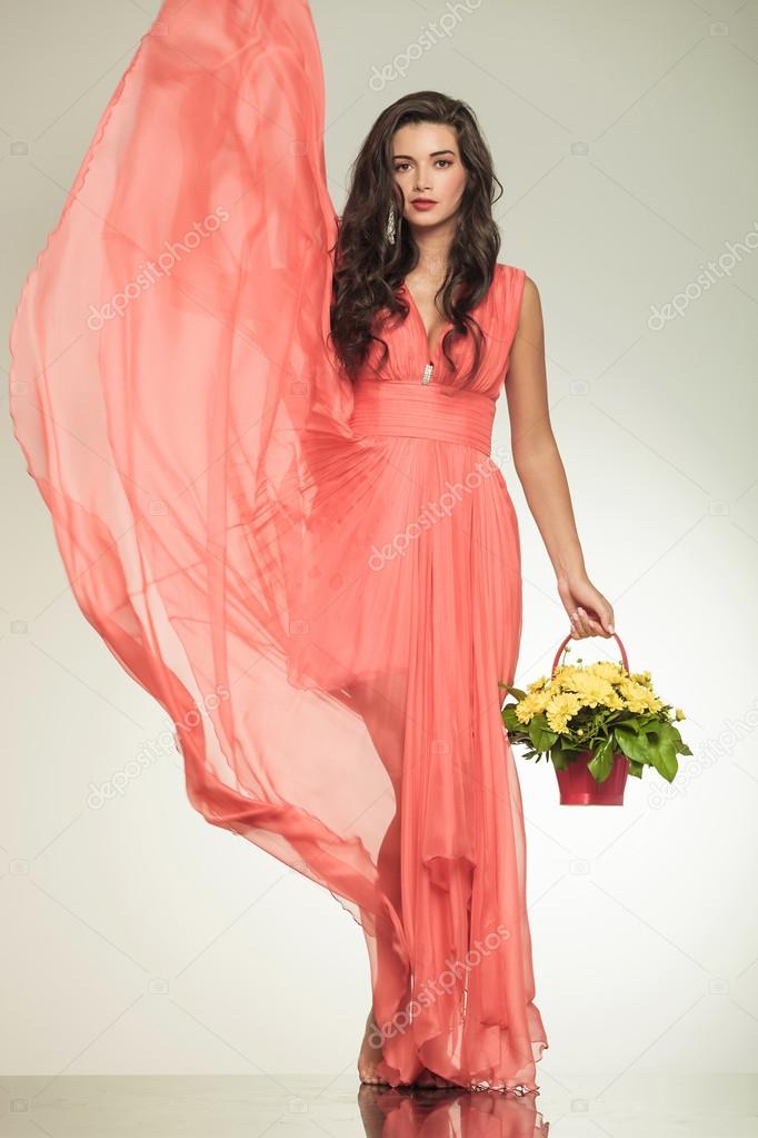 lady with fluttering red dress holding a flower basket