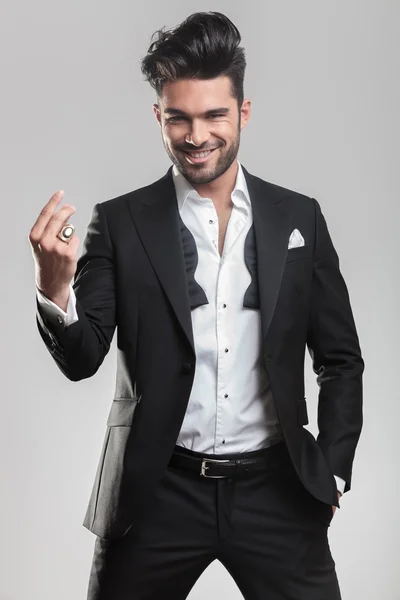 Elegant young man in tuxedo snapping his finger — Stock Photo, Image