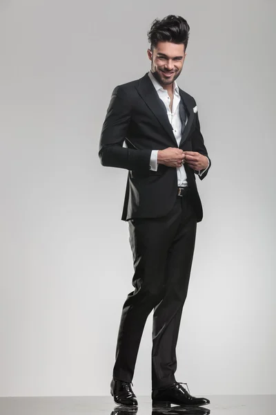 Elegant young man in tuxedo smiling for the camera — Stock Photo, Image