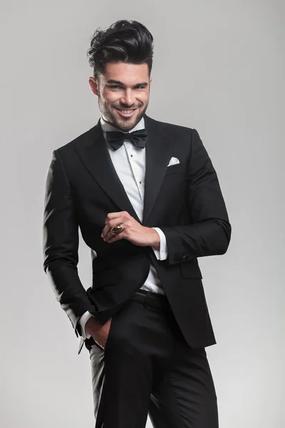 Elegant man in tuxedo holding his hand in pocket — Stock Photo, Image