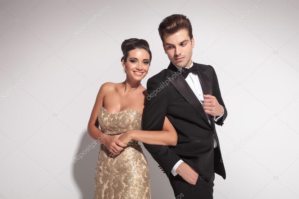 Portrait of an elegant couple holding arms